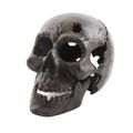 A GREY CAST IRON SKULL