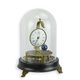 A MECHANICAL TABLE CLOCK UNDER GLASS DOME