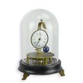 A MECHANICAL TABLE CLOCK UNDER GLASS DOME
