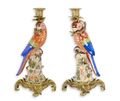 A PAIR OF BRONZE MOUNTED PORCELAIN PARROT CANDLE HOLDERS
