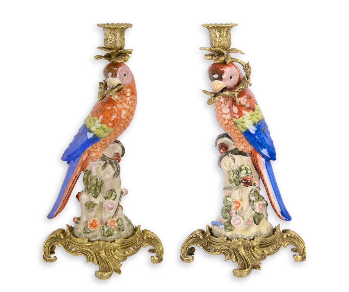 A PAIR OF BRONZE MOUNTED PORCELAIN PARROT CANDLE HOLDERS