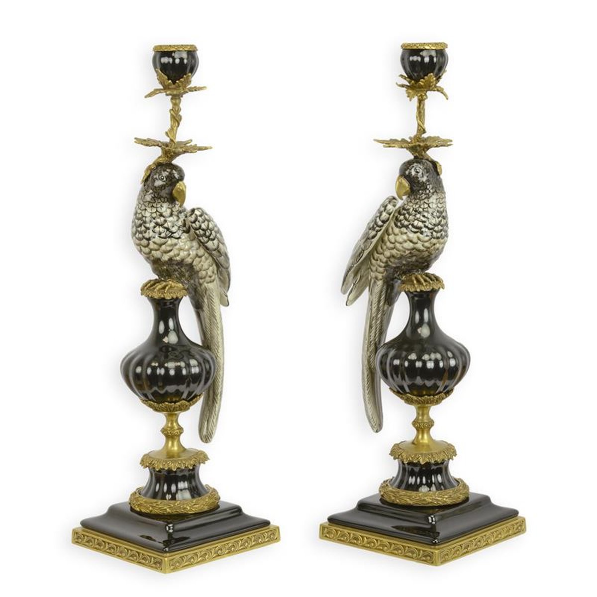 A PAIR OF BRONZE MOUNTED PORCELAIN PARROT CANDLE HOLDERS