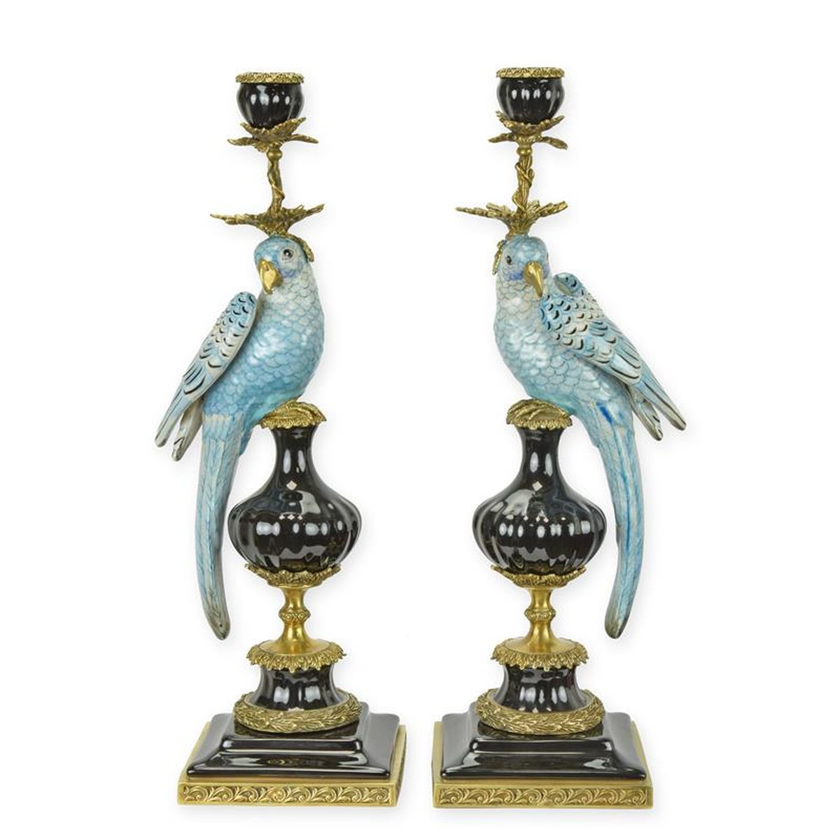 A PAIR OF BRONZE MOUNTED PORCELAIN PARROT CANDLE HOLDERS