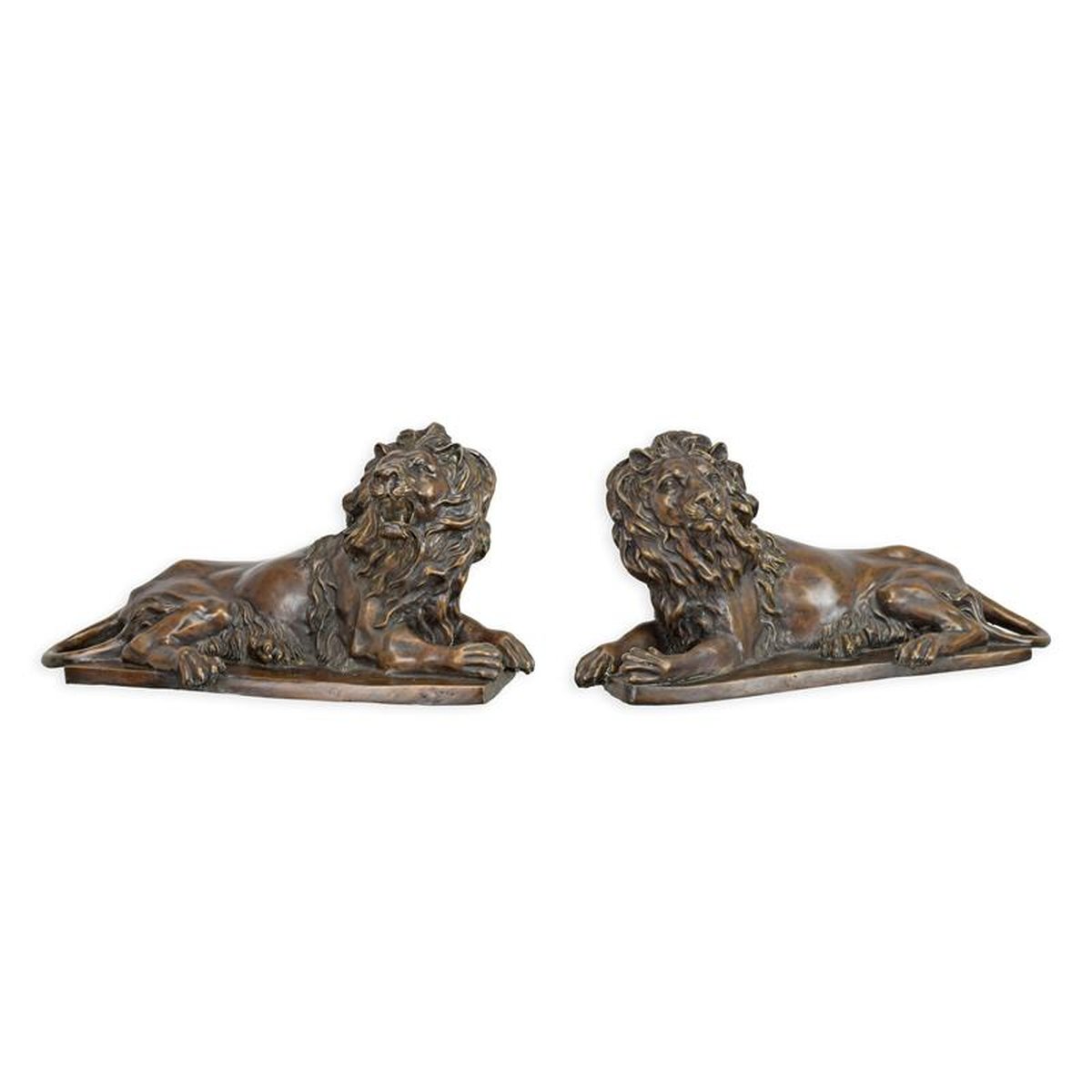 A PAIR OF BRONZE RECLINING LIONS