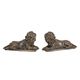 A PAIR OF BRONZE RECLINING LIONS