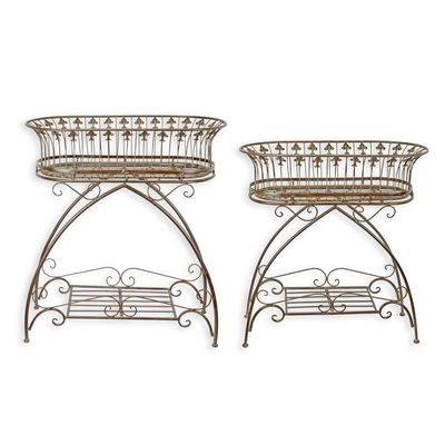 A PAIR OF BROWN IRON PLANTERS ON STAND