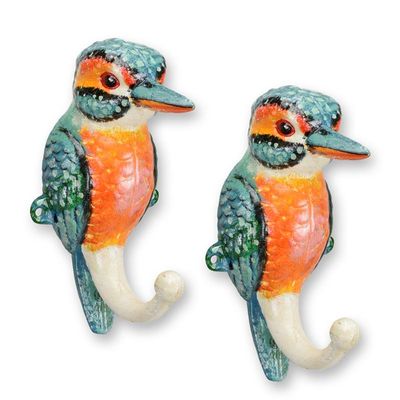 A PAIR OF CAST IRON KOOKABURRA COAT-HOOKS
