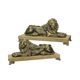 A PAIR OF CAST IRON RECLINING LIONS MOUNTED ON A WOODEN BASE