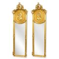A PAIR OF GOLD TRUMEAU MIRRORS