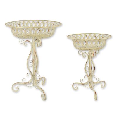 A PAIR OF IRON PLANTERS ON STAND