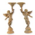 A PAIR OF RUSTY CAST IRON PUTTI CANDLESTANDS