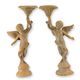 A PAIR OF RUSTY CAST IRON PUTTI CANDLESTANDS