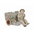 A PORCELAIN CHERUB CART