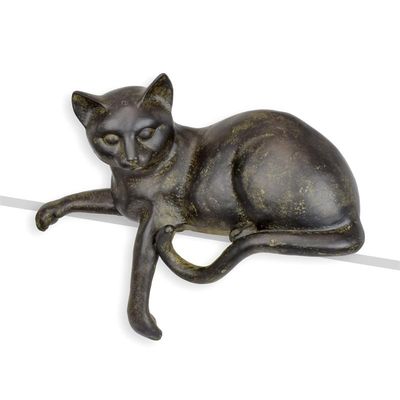 A RESIN FIGURINE OF A RECLINING CAT