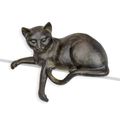 A RESIN FIGURINE OF A RECLINING CAT