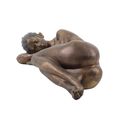 A RESIN FIGURINE OF A RESTING NUDE