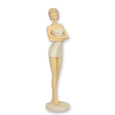 A RESIN FIGURINE OF A RETRO BEACH GIRL