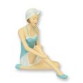 A RESIN FIGURINE OF A RETRO BEACH GIRL