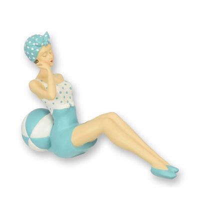 A RESIN FIGURINE OF A RETRO BEACH GIRL