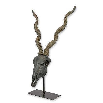 A RESIN IMPALA SKULL ON STAND