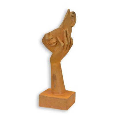A RUSTY CAST IRON FIGURINE OF A FACE RESTING ON HAND