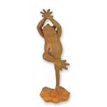 A RUSTY CAST IRON FIGURINE OF A FROG DOING YOGA