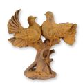 A RUSTY CAST IRON FIGURINE OF A PAIR OF PIGEONS ON BRANCH