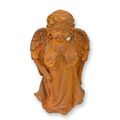 A RUSTY CAST IRON FIGURINE OF A PRAYING PUTTO