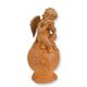 A RUSTY CAST IRON FIGURINE OF A PUTTO SITTING ON BALL
