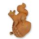 A RUSTY CAST IRON FIGURINE OF A SQUIRREL ON AN ACORN