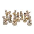 A SET OF 10 PORCELAIN PUTTI MUSICIANS