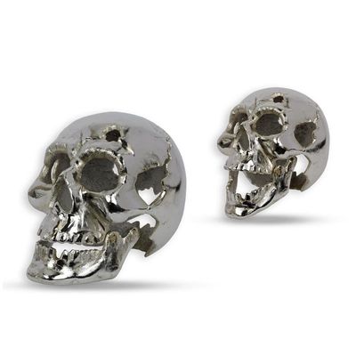 A SILVER PAINTED CAST IRON SKULL