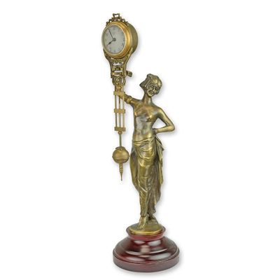 A TABLE CLOCK MYSTERIEUSE HELT BY A WOMAN