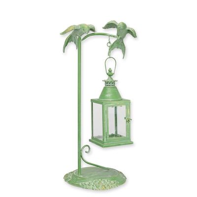 A TIN LANTERN HANGING ON A BIRD MOUNTED STANDARD