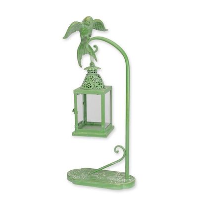 A TIN LANTERN HANGING ON A BIRD MOUNTED STANDARD