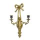 A TWO LIGHT PORCELAIN MOUNTED BRONZE WALL APPLIQUE