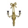A TWO LIGHT PORCELAIN MOUNTED BRONZE WALL APPLIQUE