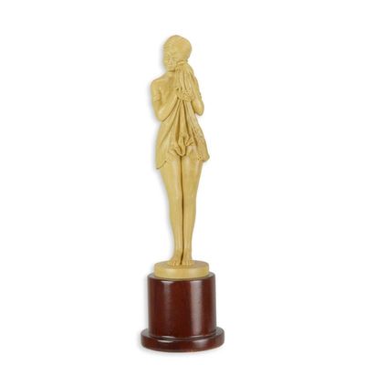 A WOODEN SCULPTURE OF THE SAD GIRL