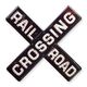 AN EMBOSSED TIN PLATE - RAILROAD CROSSING