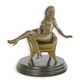 AN EROTIC BRONZE SCULPTURE OF A SEATED FEMALE NUDE