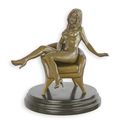 AN EROTIC BRONZE SCULPTURE OF A SEATED FEMALE NUDE
