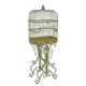 AN IRON BIRDCAGE ON STAND